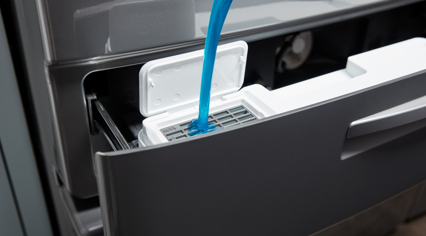 Detergent being loaded into a washer dispenser
