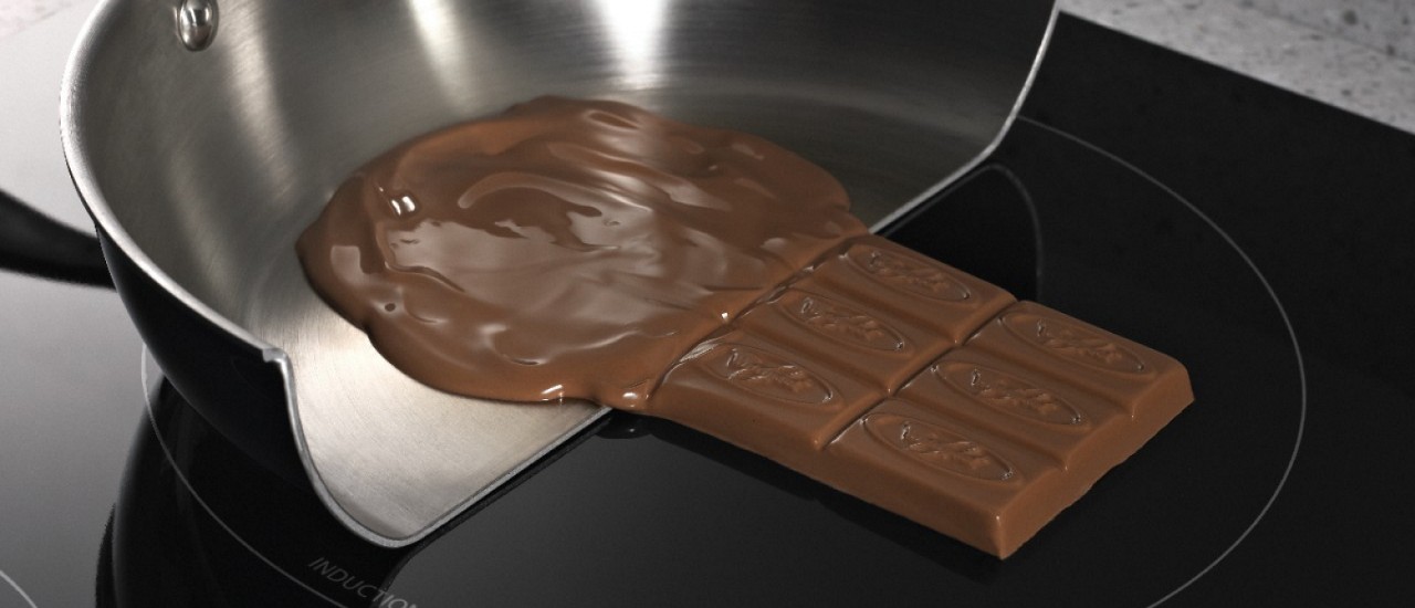 Chocolate melting in a pan and solid on an induction cooktop surface 
