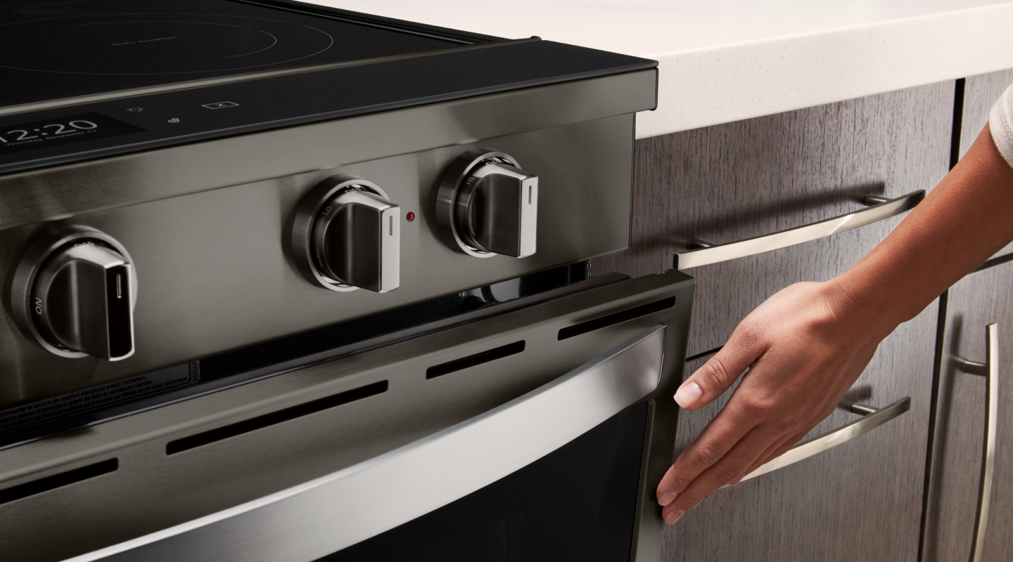 Person touching door of oven