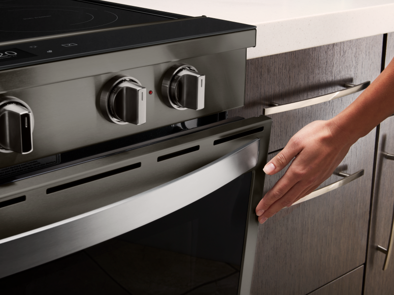 Person touching door of oven
