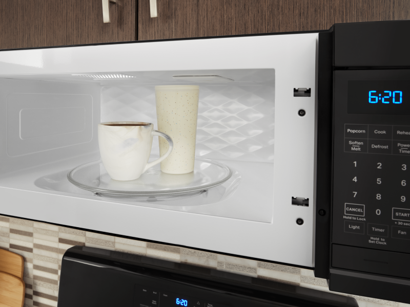 Two drink cups in a microwave