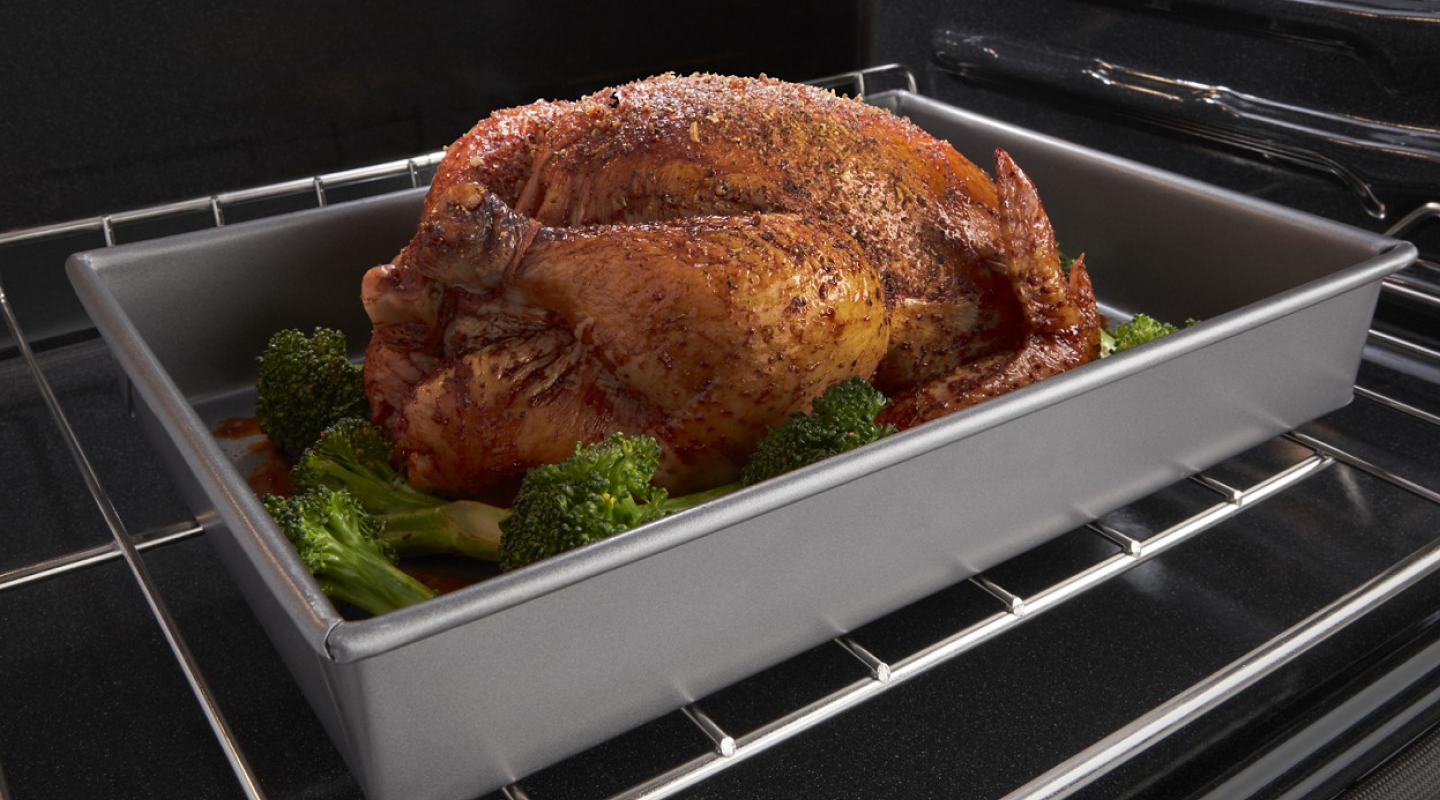 Whole chicken roasting in oven