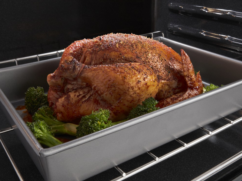 Whole chicken roasting in oven