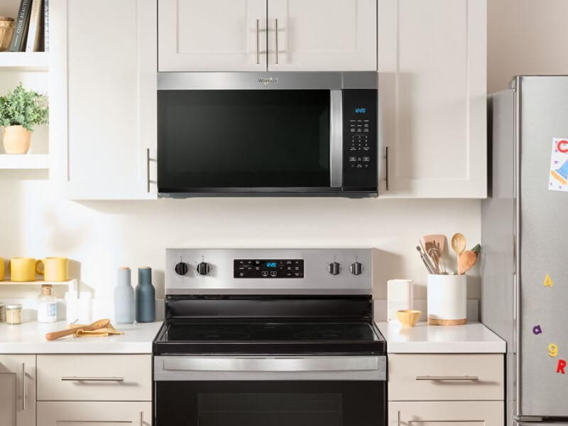 Whirlpool® Over-the-Range Microwave and Electric Range in cream and white cabinetry