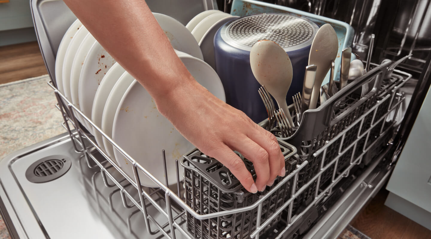 Person loading a dishwasher