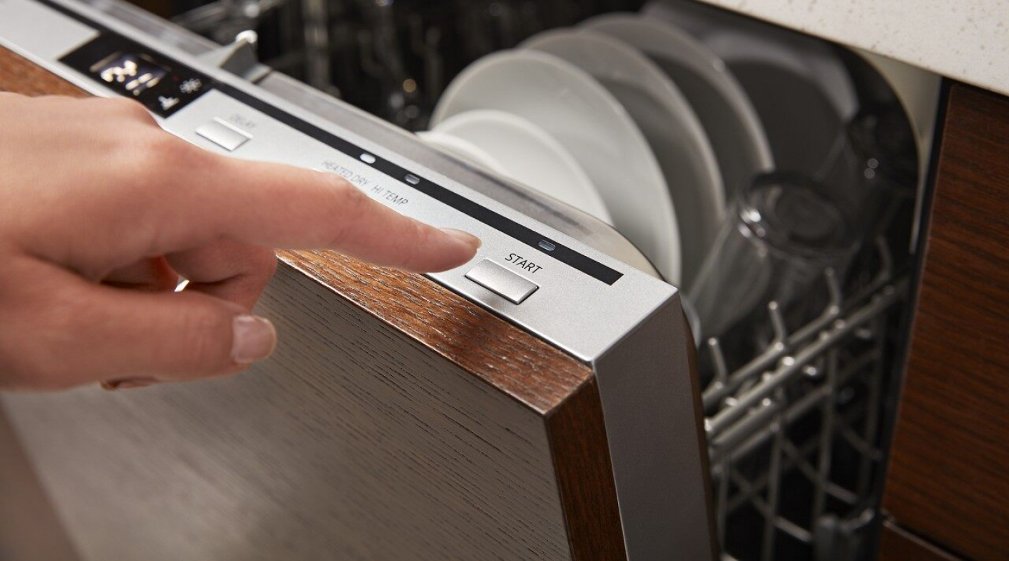 Person selecting a cycle on a dishwasher