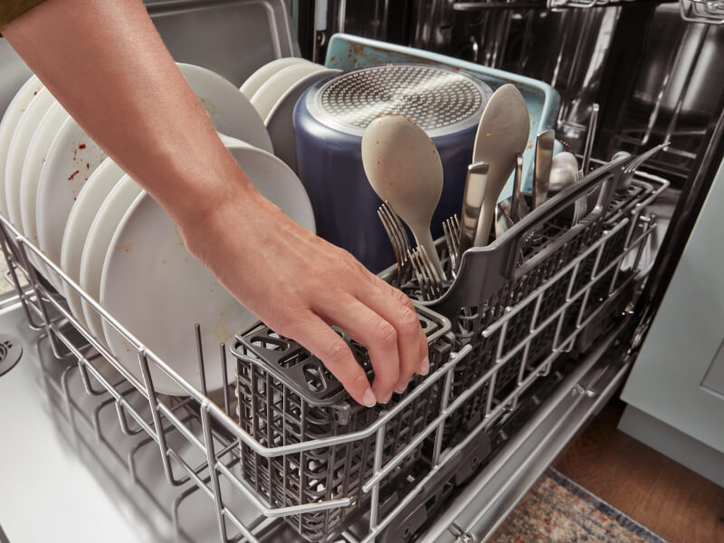 Person loading a dishwasher