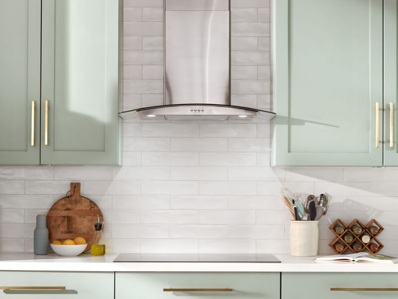 Range hood installed over an electric cooktop in a rustic kitchen