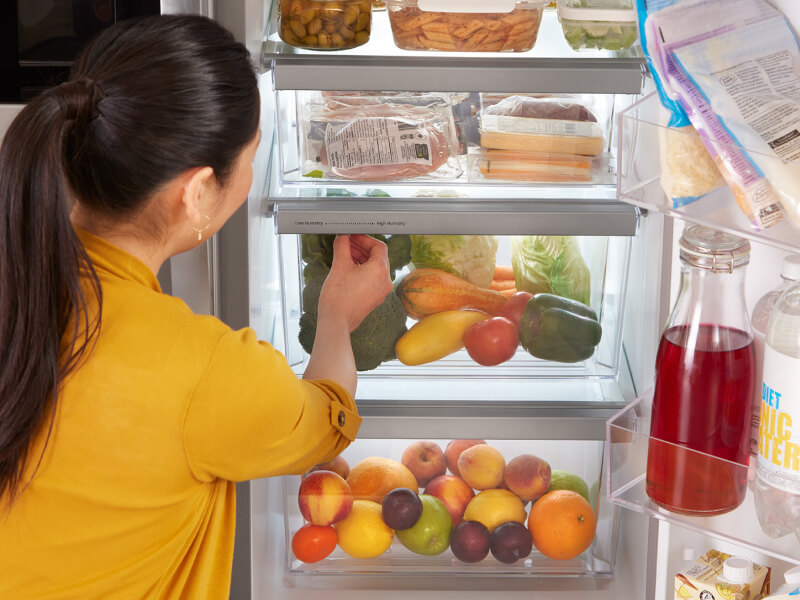 A person getting food out of their fridge
