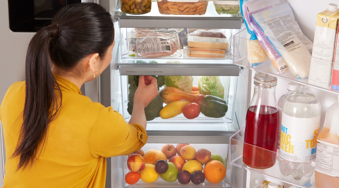 A person getting food out of their fridge