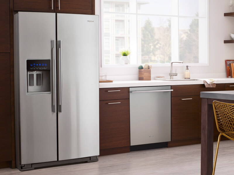 A modern wood cabinet kitchen with a counter depth refrigerator