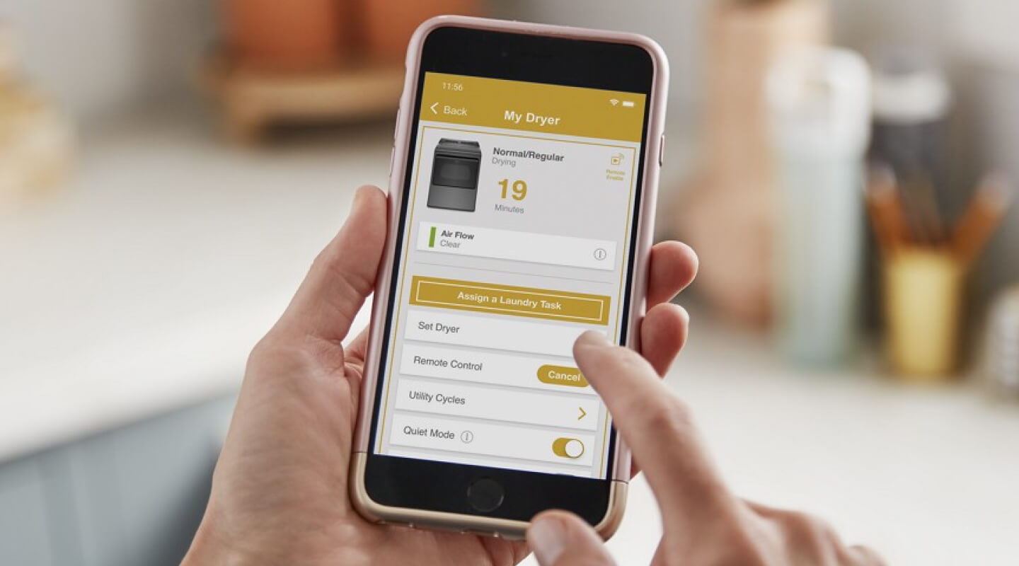 Person adjusting dryer settings on the Whirlpool® App