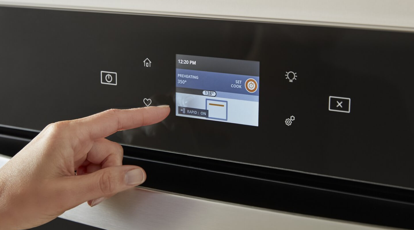 Person selecting settings on an appliance touchscreen