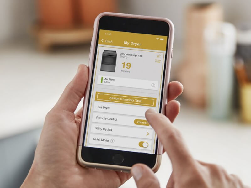 Person adjusting dryer settings on the Whirlpool® App