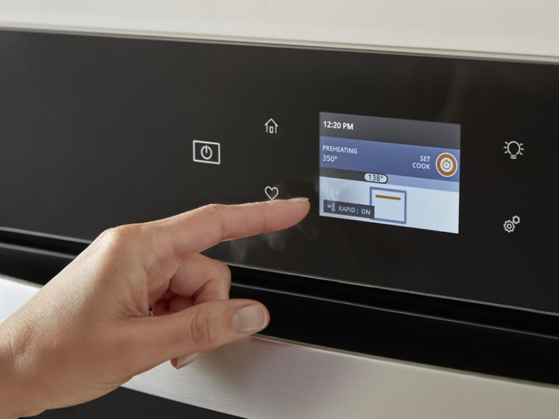 Person selecting settings on an appliance touchscreen