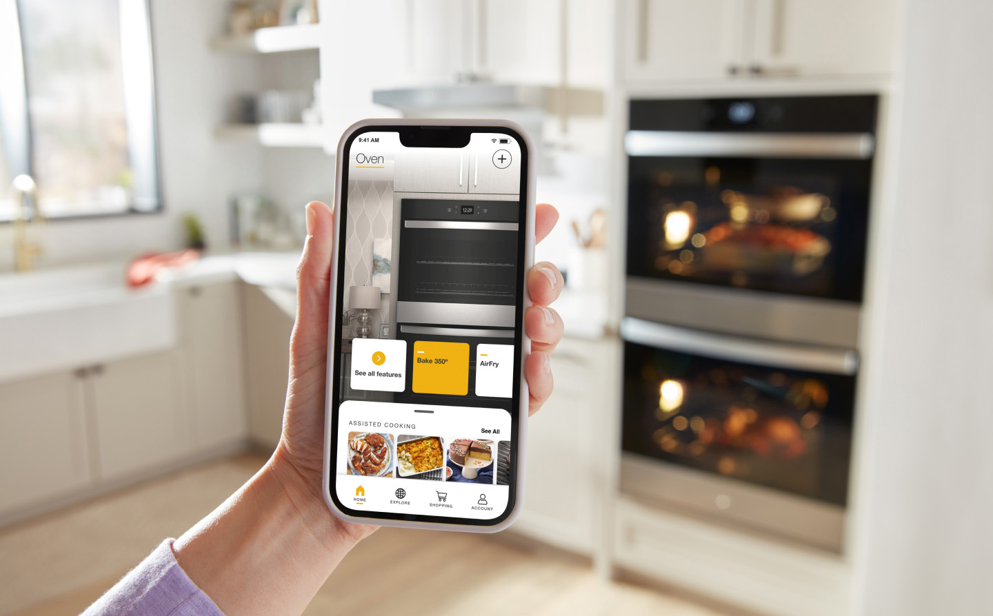 Person holding a smartphone in a kitchen