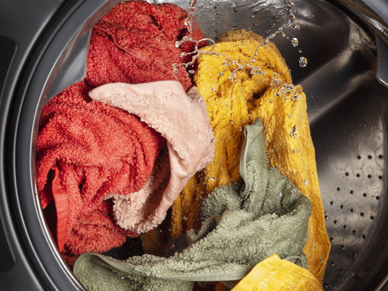 The inside of a washer with a load of laundry in the middle of a wash cycle