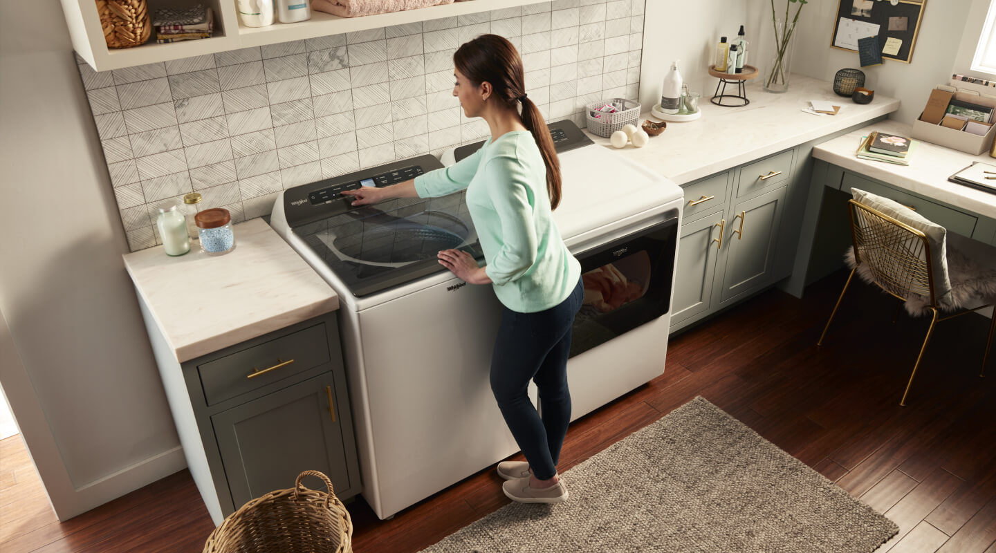 Person making a selection on a washing machine control panel