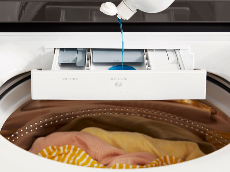 Detergent pouring into a detergent dispenser on a Whirlpool® Washer