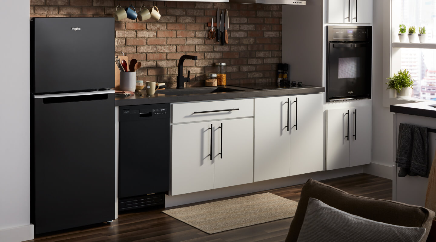 The interior of a kitchen with a top freezer in it from Whirlpool brand