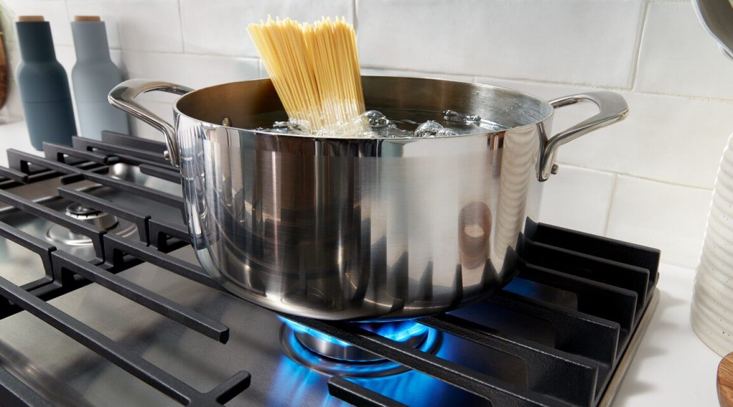 Pasta cooking in a pot on a gas cooktop