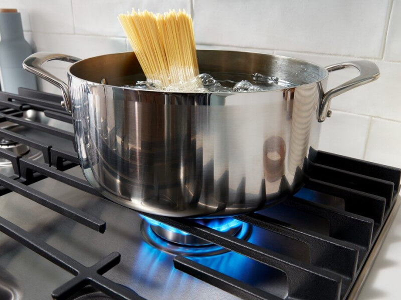 Pasta cooking in a pot on a gas cooktop