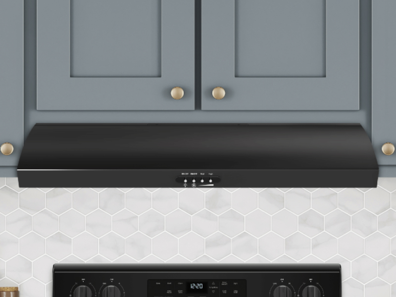 Black undercabinet hood under blue shaker cabinets