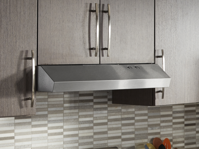 Undercabinet hood installed beneath modern wood cabinets