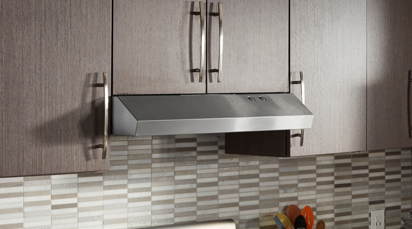 Undercabinet hood installed beneath modern wood cabinets