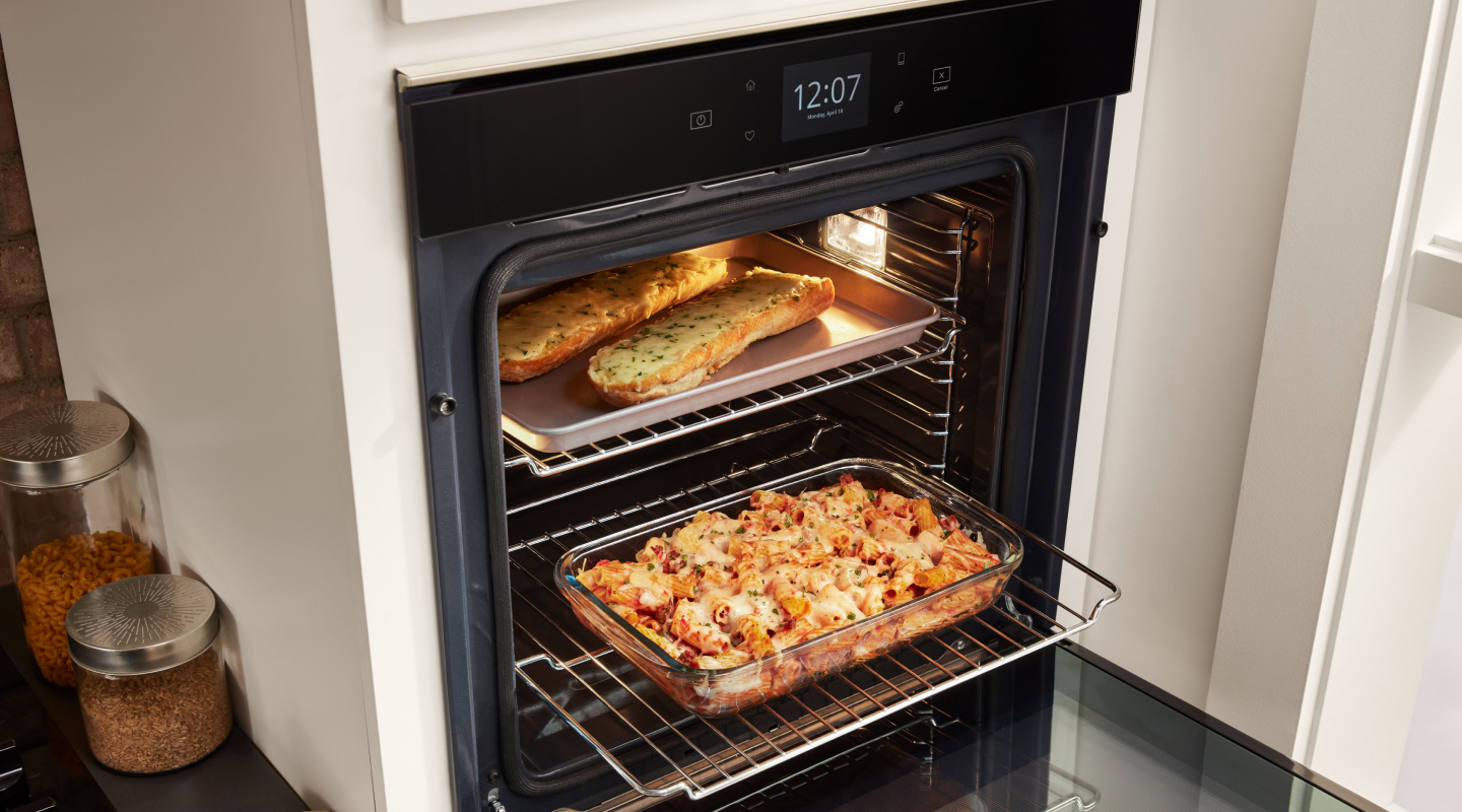Various dishes cooking in a single wall oven