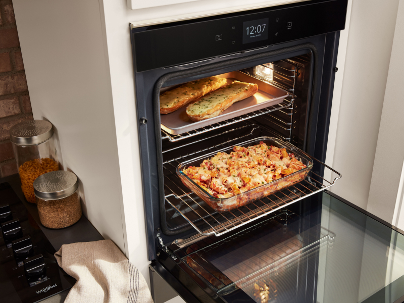 Various dishes cooking in a single wall oven