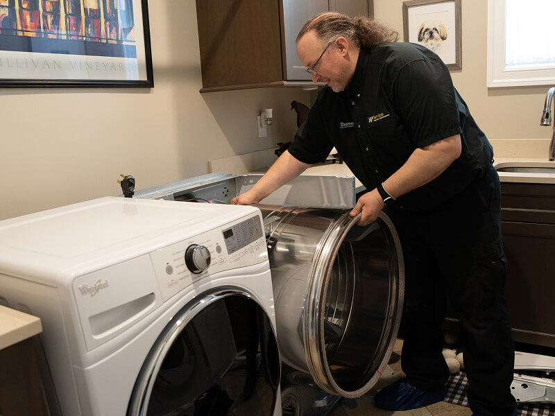 A technician working on a dryer