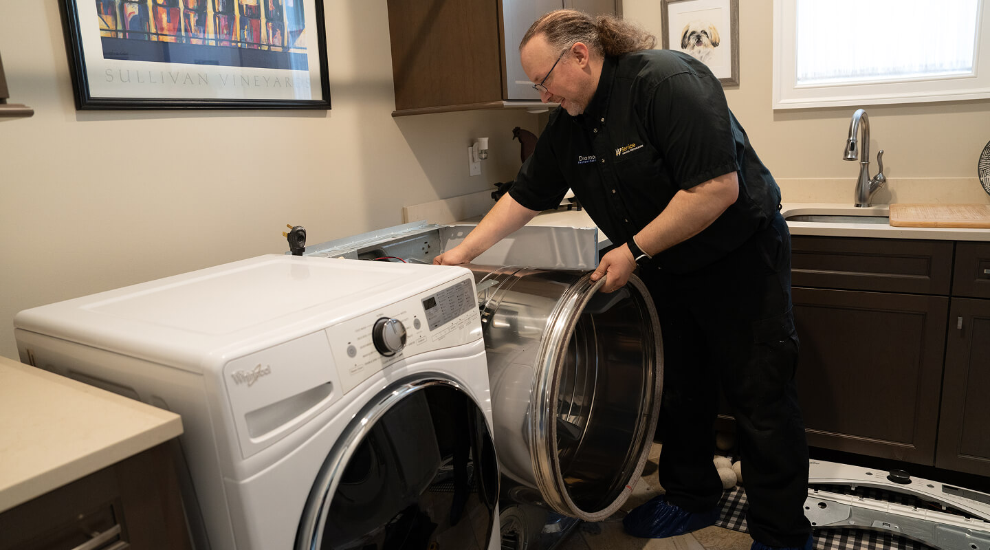 A technician working on a dryer