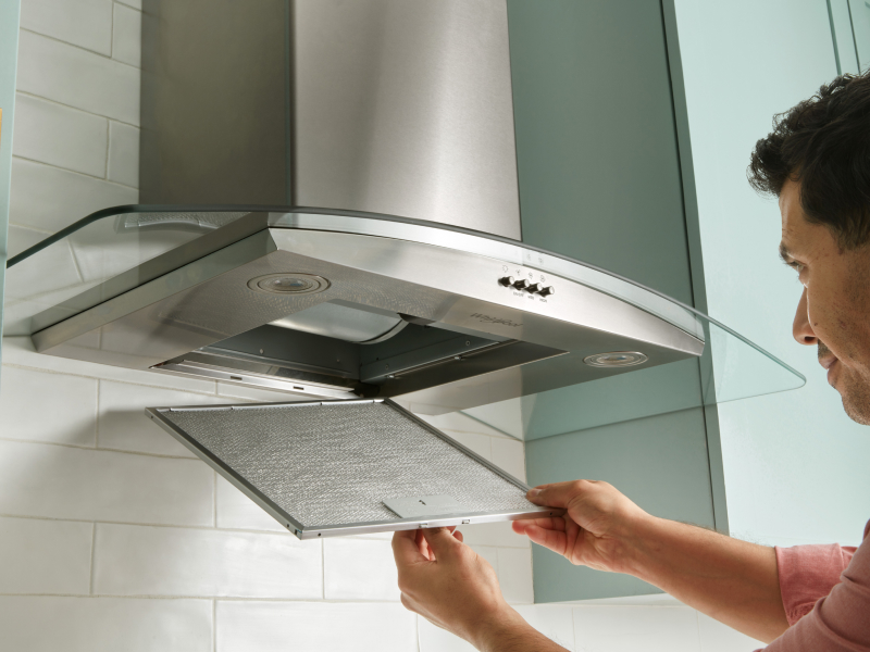 Person removing range hood filter
