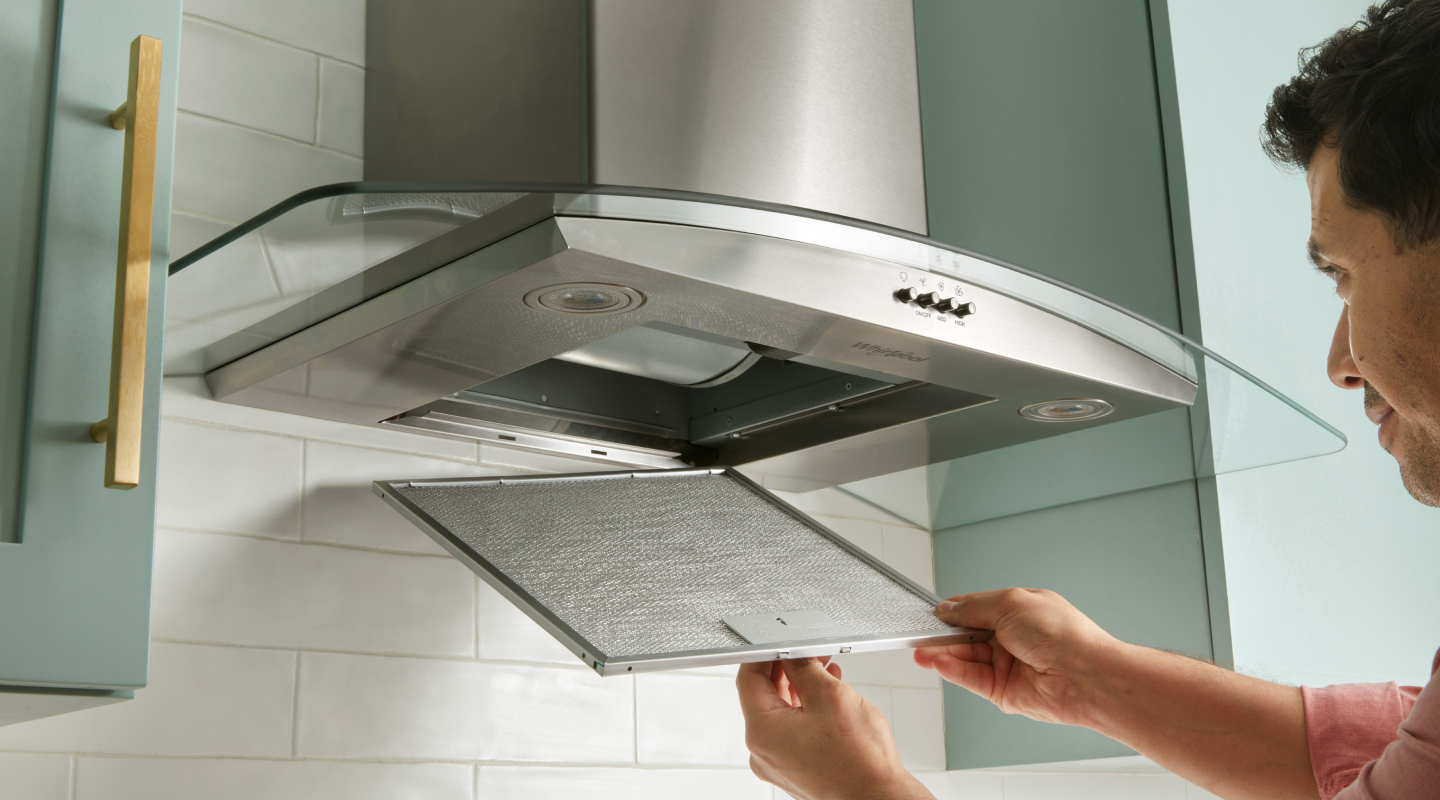 Person removing range hood filter