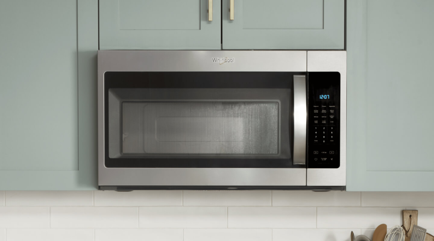 Stainless, Whirlpool® Over-The-Range Microwave in blue green cabinetry 