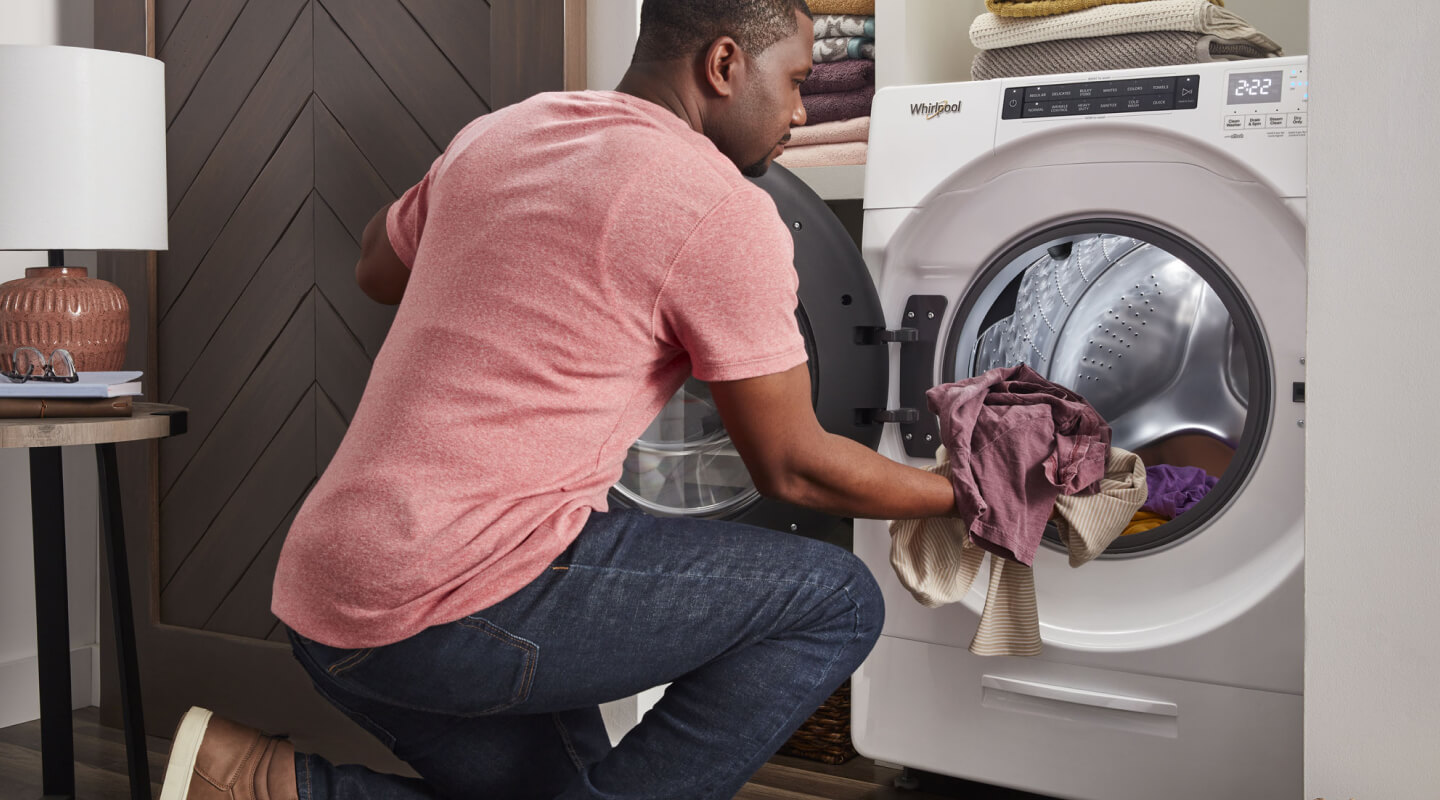 A person loading laundry into a Whirlpool® All-In-One Washer Dryer Combo