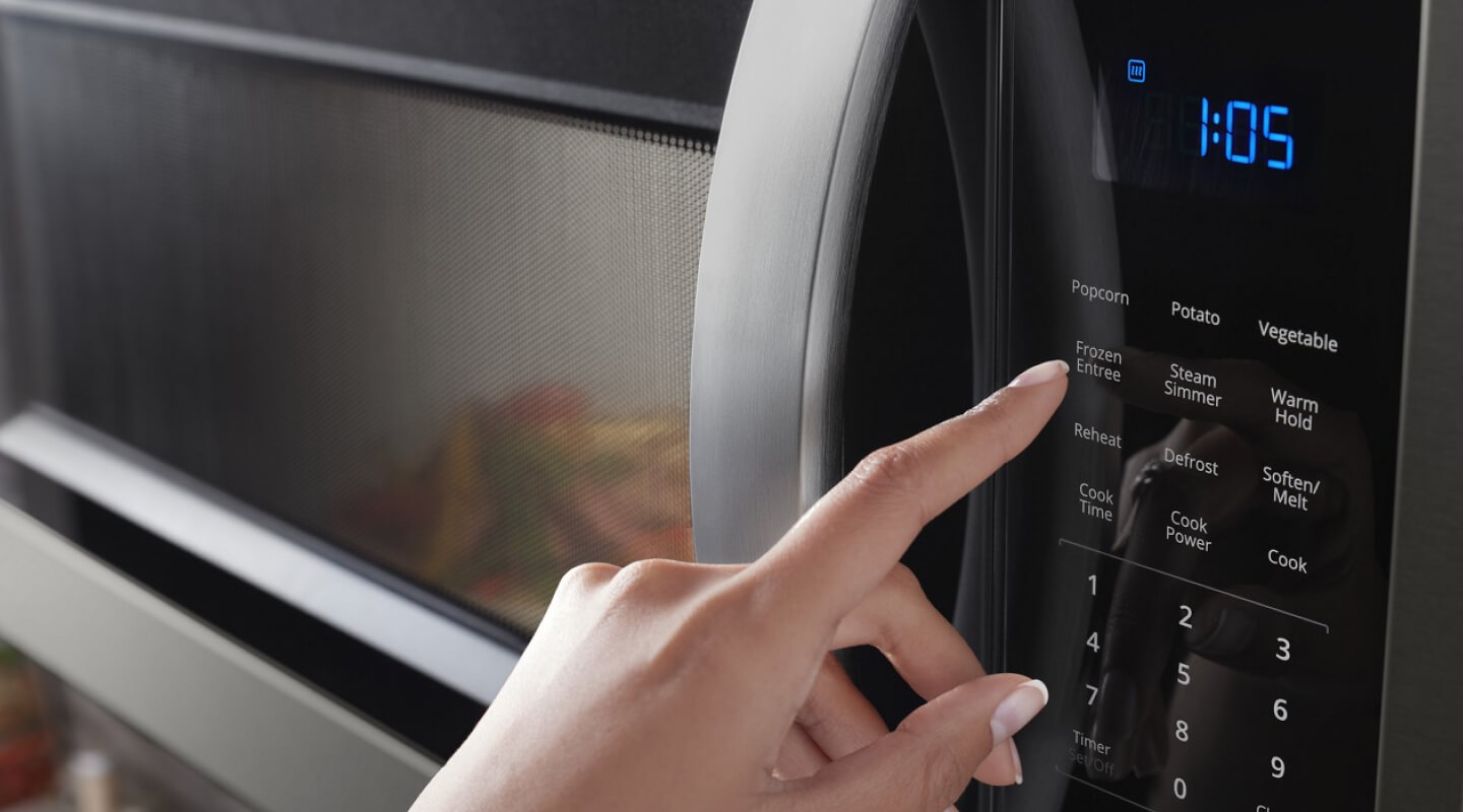 person operating a microwave