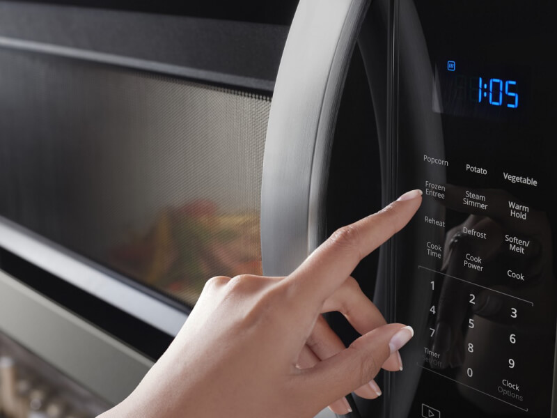 person operating a microwave
