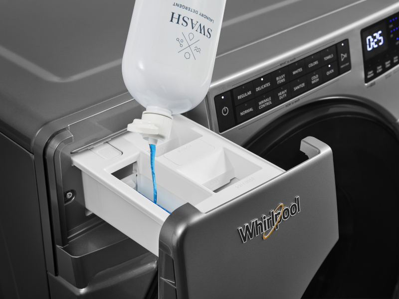 Swash® laundry detergent poured into the dispenser drawer of a Whirlpool® washing machine