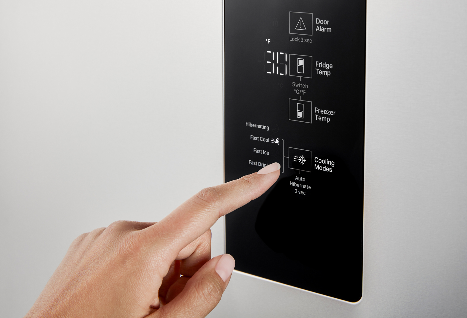 Close up shot of hand selecting cooling modes setting on freezer