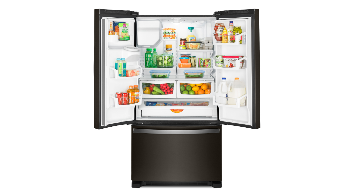 A Whirlpool® French door refrigerator with food inside
