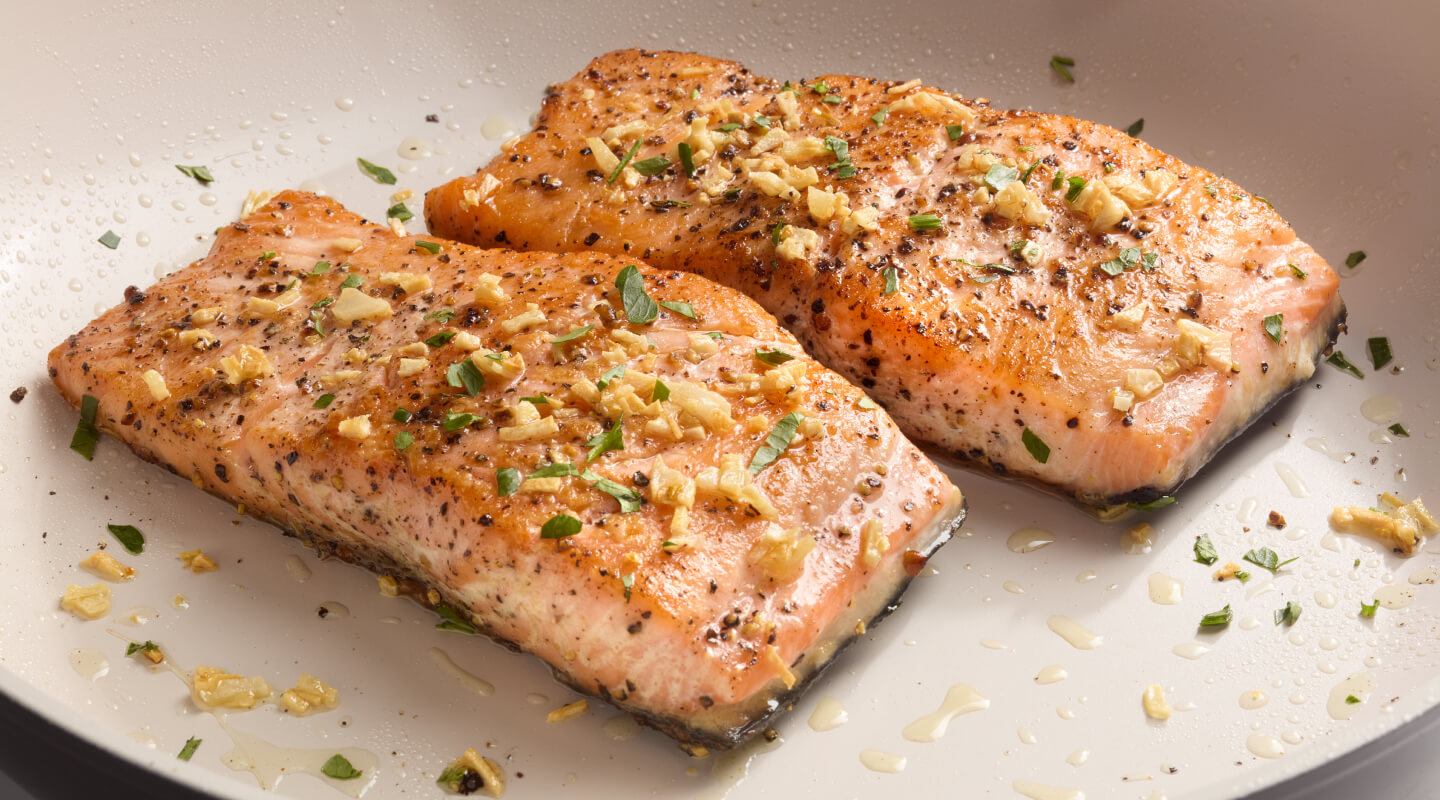 Two seasoned salmon fillets on a plate