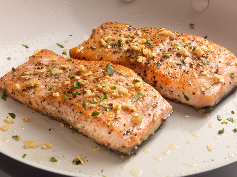 Two seasoned salmon fillets on a plate