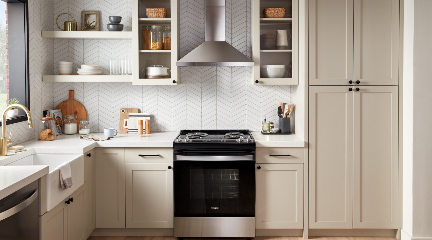 Stainless steel range hood above a Whirlpool® range