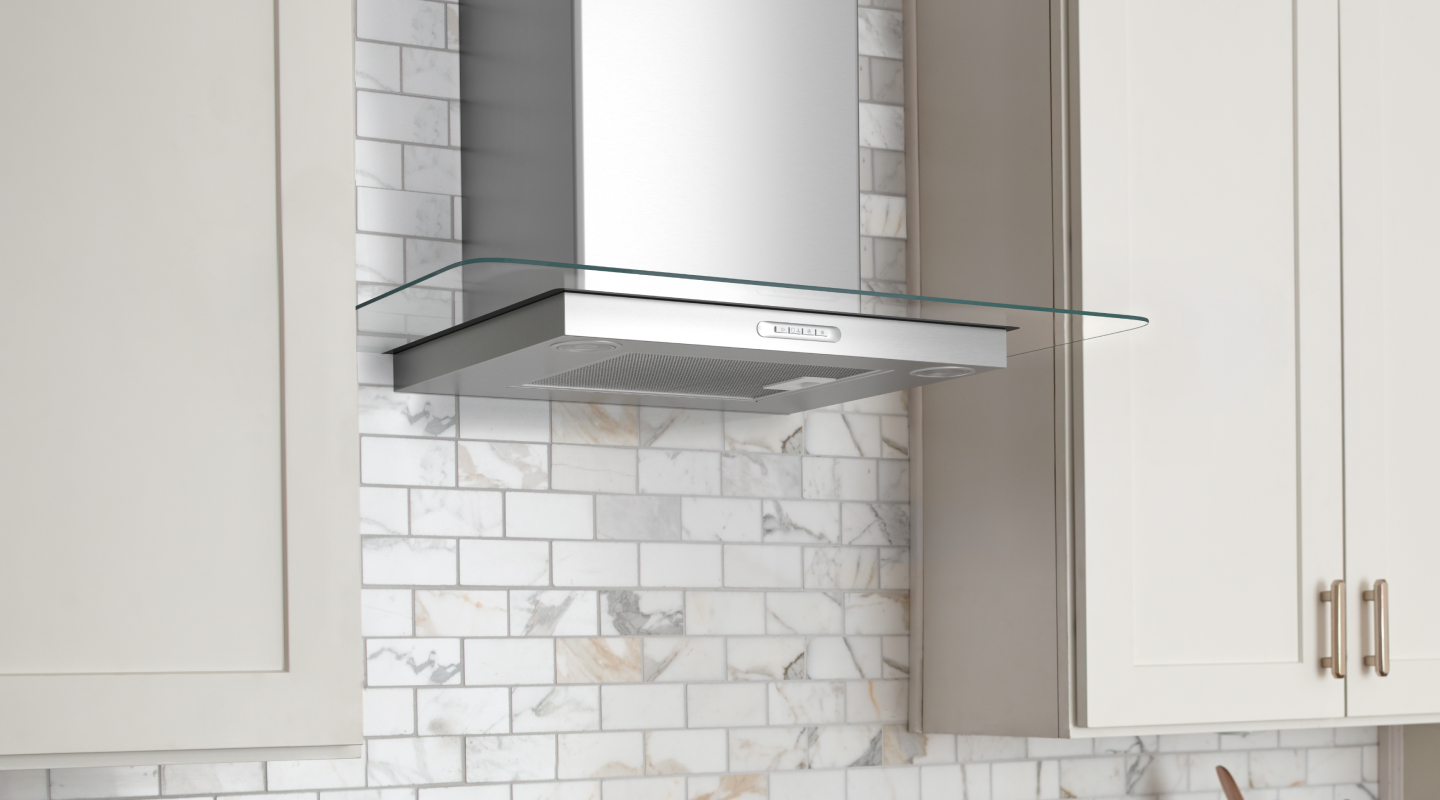 Stainless steel range hood between white cabinetry