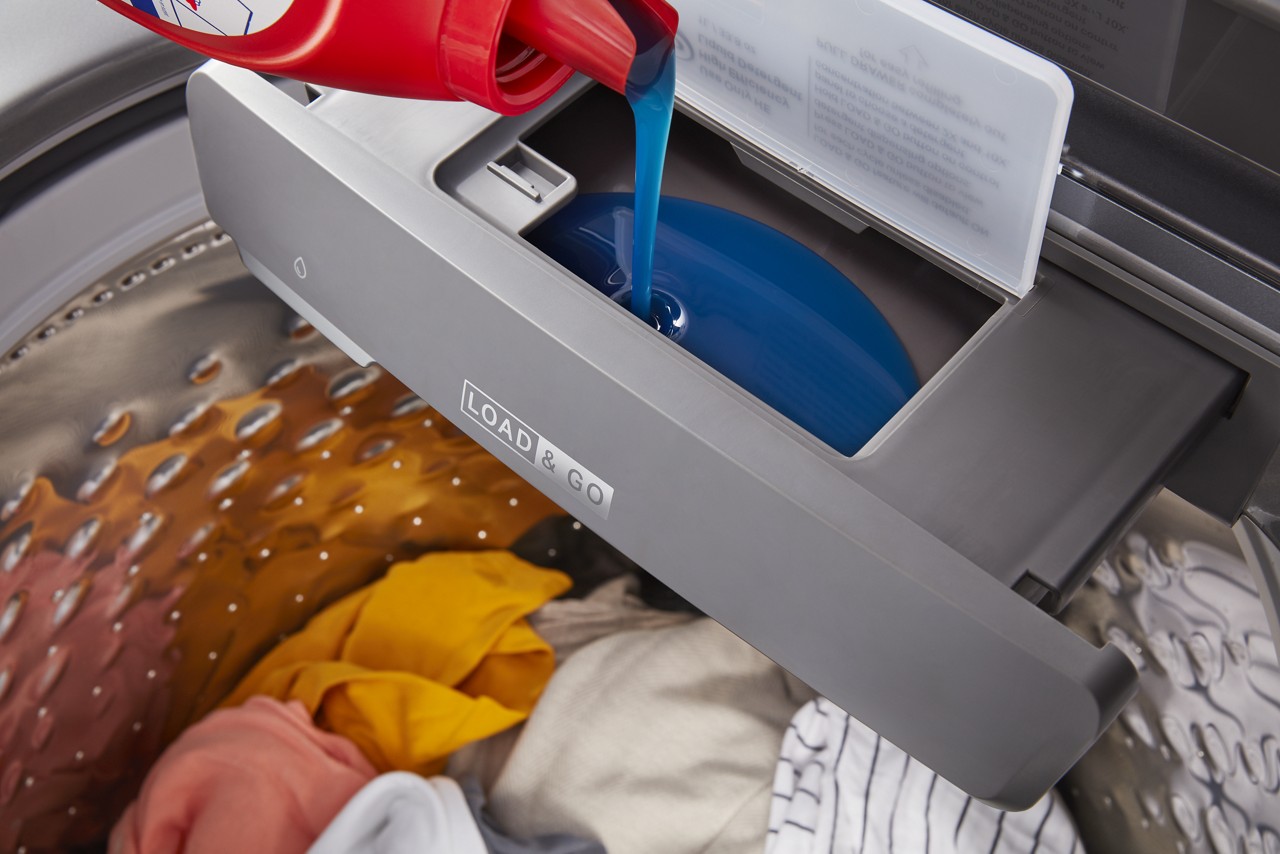Detergent being poured into a Whirlpool® Load & Go™ Dispenser