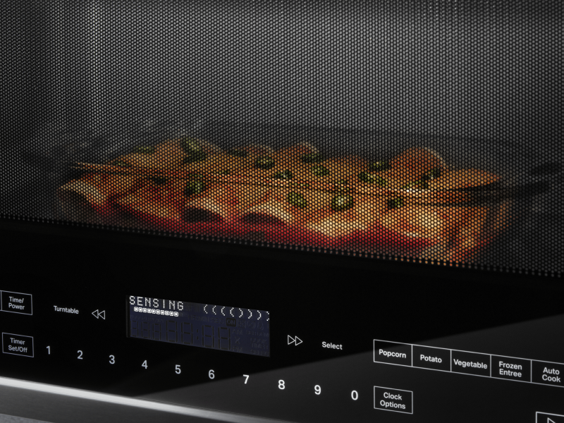 A closeup of enchiladas cooking in a Whirlpool® microwave.