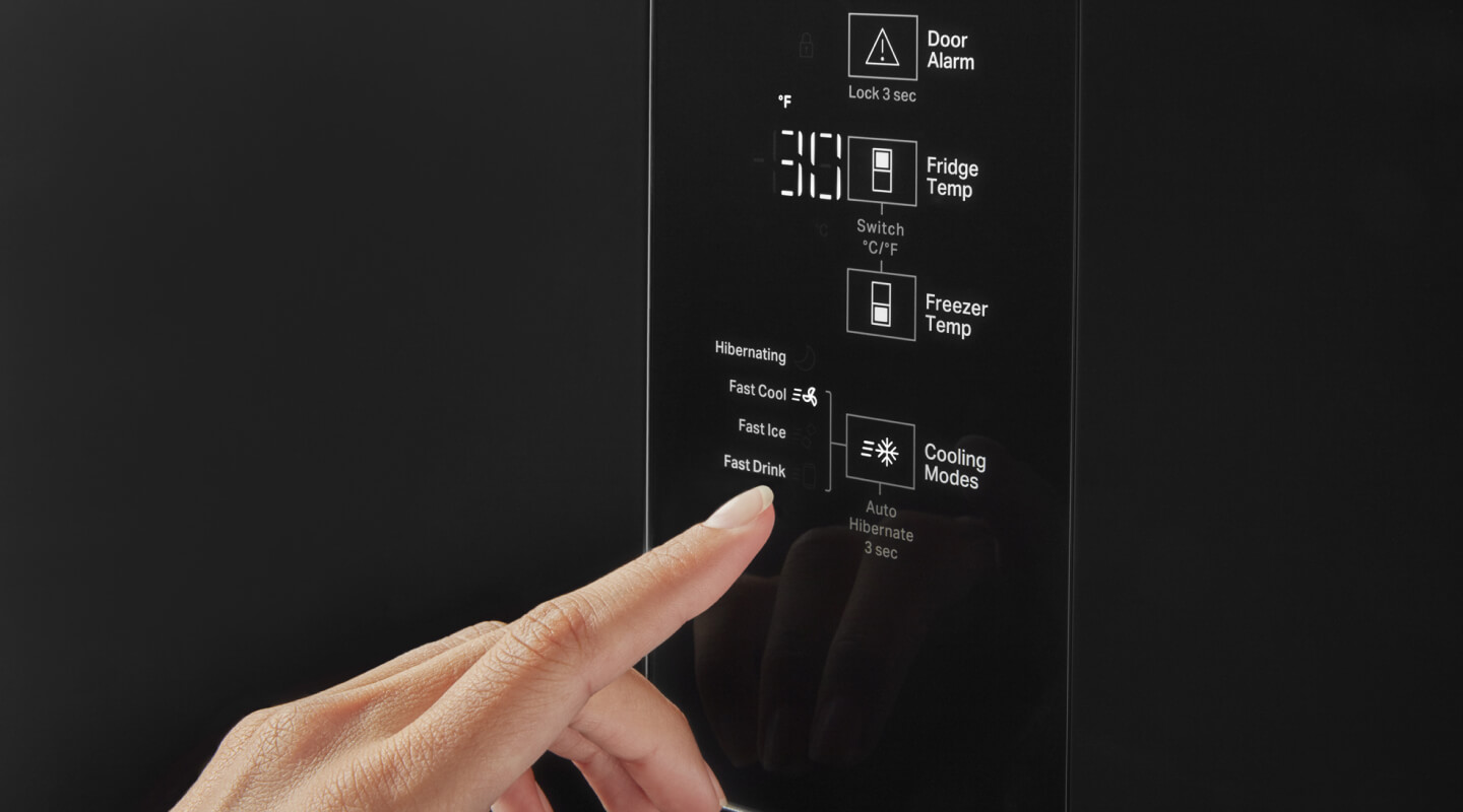 A person selecting the freezer temperature