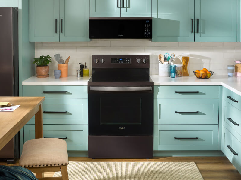 A kitchen with an over-the-range microwave